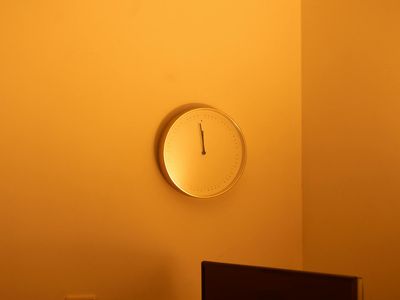 Digital clock showing noon with minimalist interior
