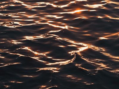 Sunset colors reflected on a calm water surface